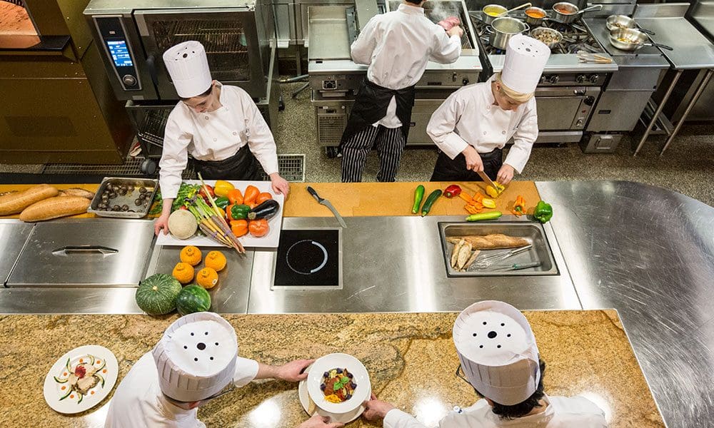 a-view-looking-down-on-a-crew-of-chefs-working-in