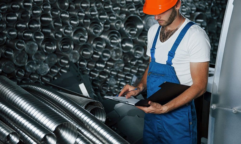 many-of-ventilation-pipes-man-in-uniform-works